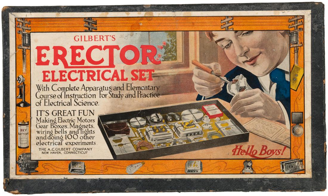 GILBERT "ERECTOR ELECTRICAL SET" BOXED 1917 SET.: 11.25x19.25x1.75" deep cardboard box w/illustrated lid contains A.C. Gilbert Co. set, 1917. Lid features image of boy w/electrical components and working on apparatus. Box shows obvious wear w/glue re