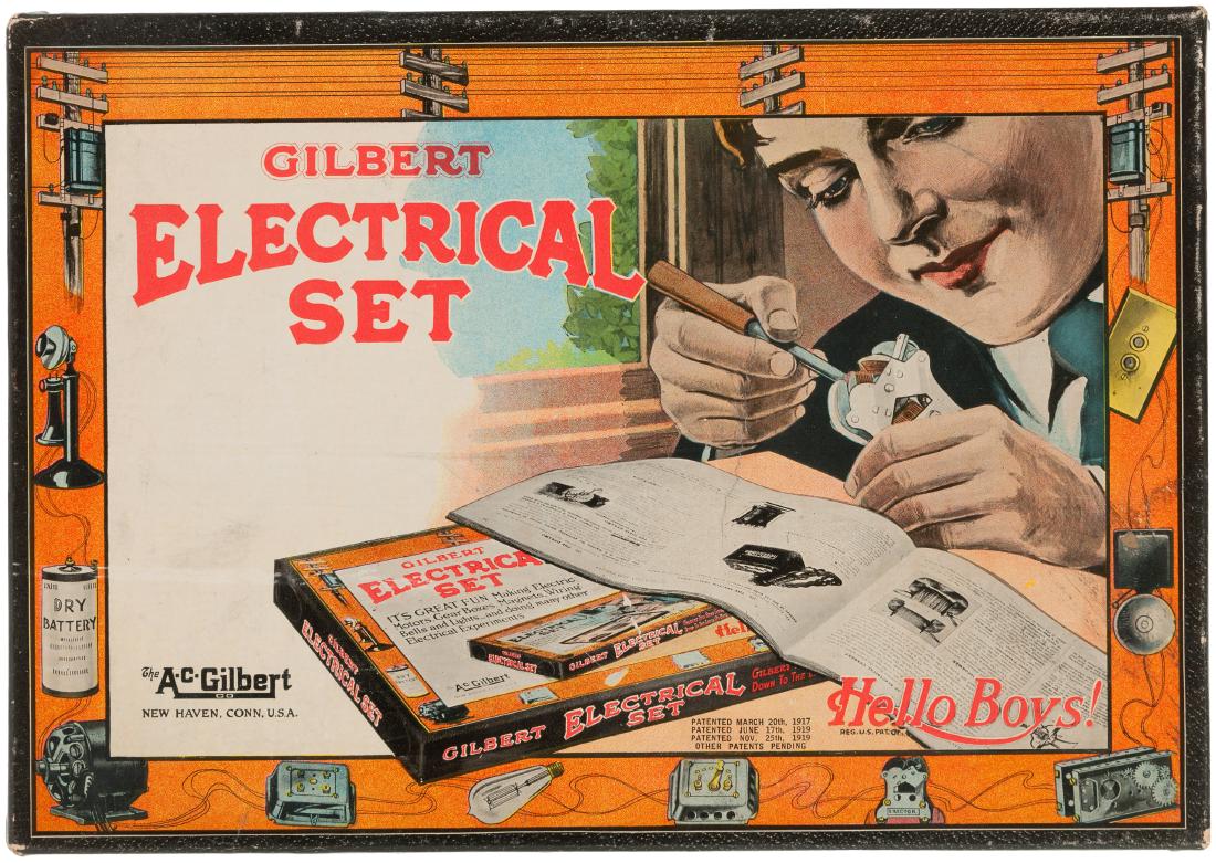 "GILBERT ELECTRICAL SET" BOXED 1922 SET.: 8.5x12-3/8x1" deep cardboard box w/illustrated lid label contains A.C. Gilbert Co. set No. 3002, 1922 . Lid label features image of boy working on electrical apparatus w/this set spread before him. Bo