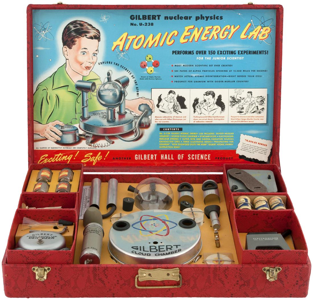 "GILBERT NUCLEAR PHYSICS NO. U-238 ATOMIC ENERGY LAB" B: 16.5x25.25x4.75" deep textured paper-covered case contains A.C. Gilbert Co. set No. U-238 (a clever reference to Uranium-238, the most common isotope of uranium found in nature). This infamous lab's i