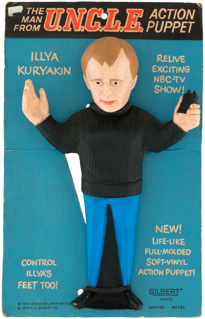 "THE MAN FROM U.N.C.L.E." ILLYA KURYAKIN ACTION PUPPET.: 10x15.75" card contains 13" tall soft vinyl full figure puppet. Illya is depicted holding a communicator. Made by Gilbert, who also produced similar puppets for James Bond and Odd Job. 1965. Card is p