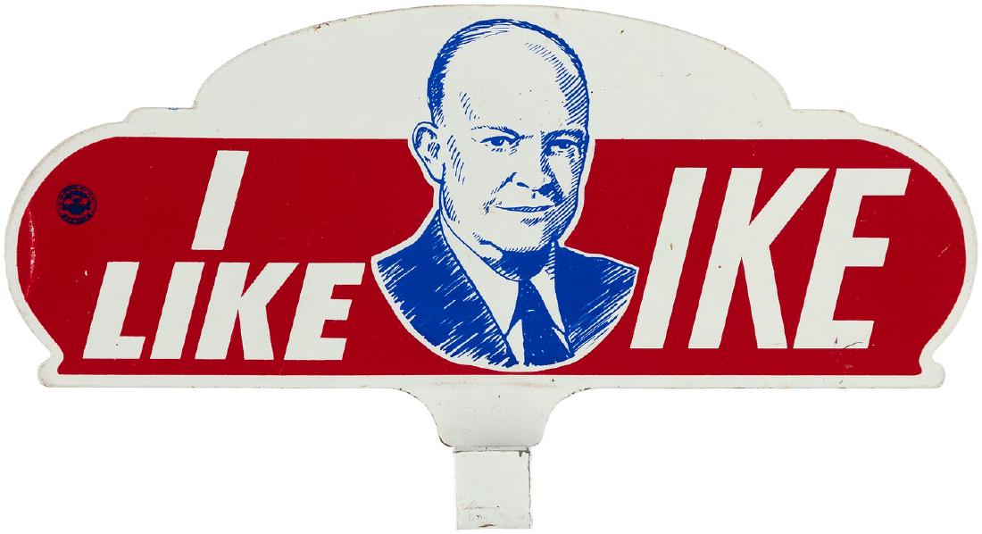 "I LIKE IKE" PORTRAIT LICENSE PLATE TOPPER.: 5x9.25". 1952. Thin metal plate w/screw mount "C" base. A striking likeness of Ike flanked by the most iconic slogan in American political history. Light paint wear most notably a 1/8x1" vertical line