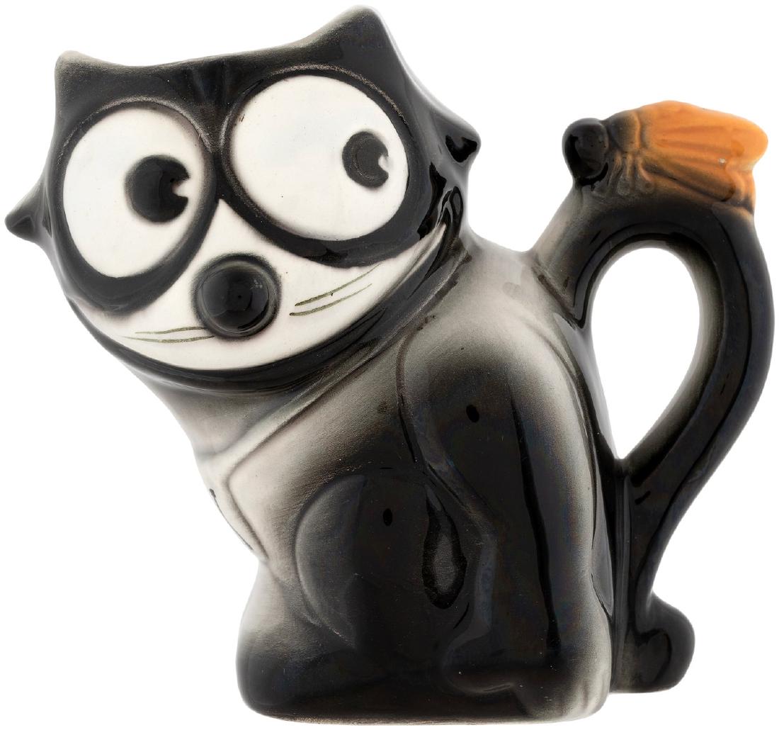 "FELIX" THE CAT FIGURAL CHINA PITCHER.: 6" tall high glaze figural pitcher shows a big-eyed Felix looking at fly on his tail handle. His name appears in large .5" tall letters on front of collar. Made in Czechoslovakia, bottom is marked "Ma