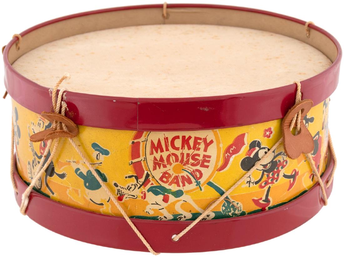 "MICKEY MOUSE BAND" DRUM (SIZE VARIETY).: 11" dia. by 4.75" tall; the middle of three sizes (see largest size, item #1687) produced by Noble & Cooley, who produced many different Mickey toy instruments (see tambourine, item #1686). 1930s. Tin