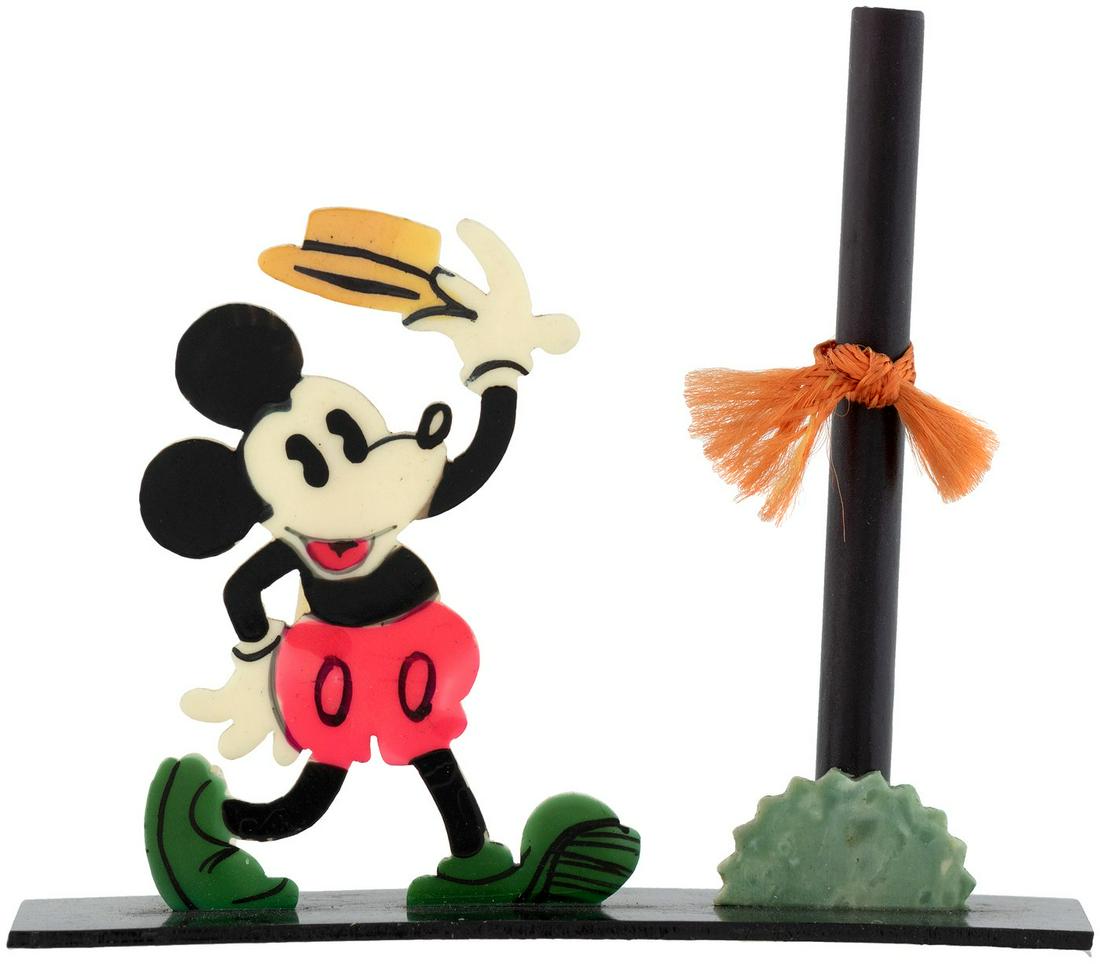 MICKEY MOUSE CELLULOID PLACE CARD & FLOWER HOLDER.: MICKEY MOUSE CELLULOID PLACE CARD & FLOWER HOLDER. 2.5" tall all celluloid including die-cut figure of Mickey Mouse tipping his hat and designed to hold a place card. Also features small tube designed