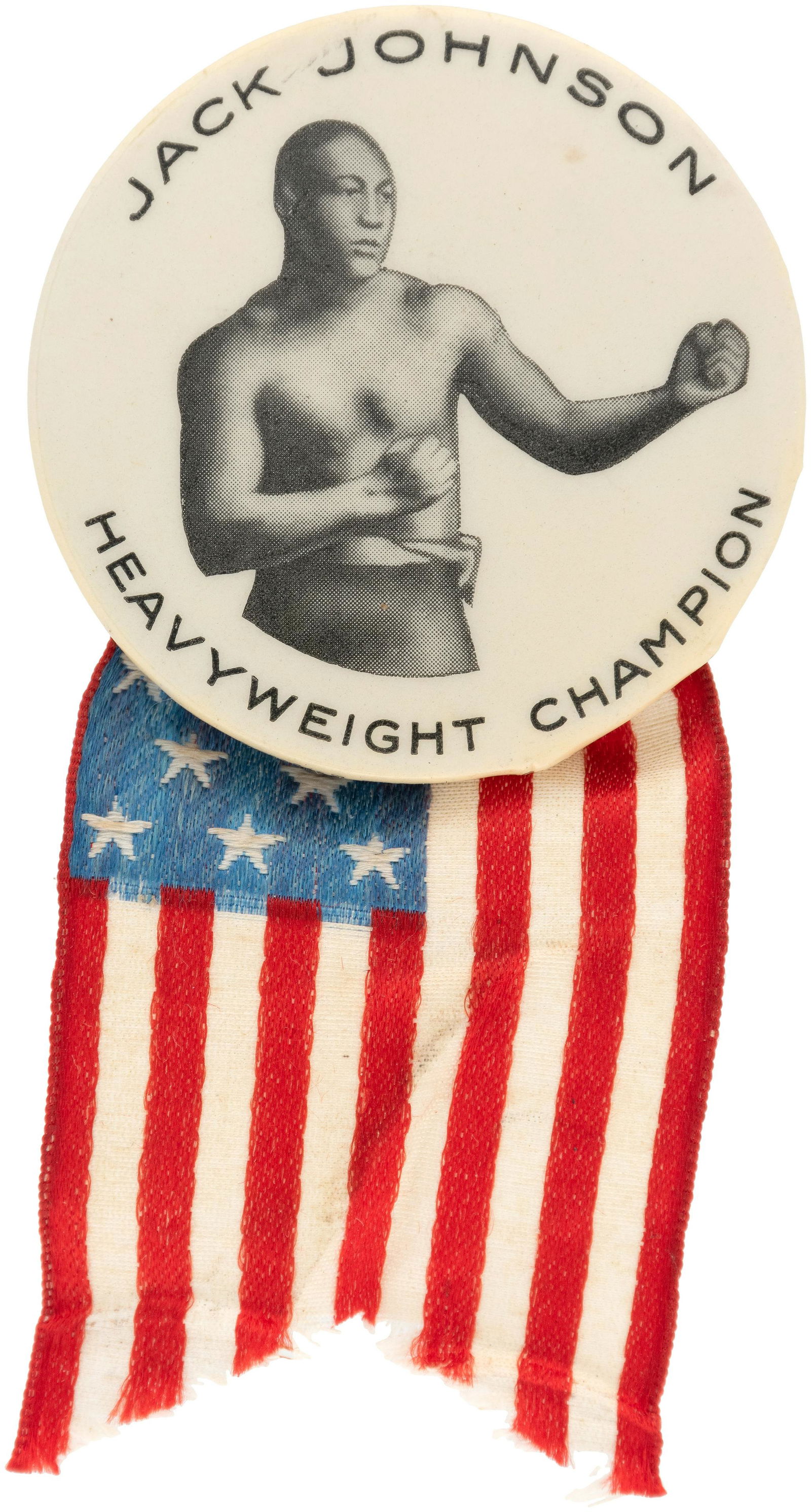 "JACK JOHNSON HEAVYWEIGHT CHAMPION" BUTTON.: 1.75" with back paper of Bastian, Rochester (and their name on the curl) and spring pin holding American flag ribbon. Produced for his 1910 Reno bout vs. J. J. Jefferies. See the following related, bu