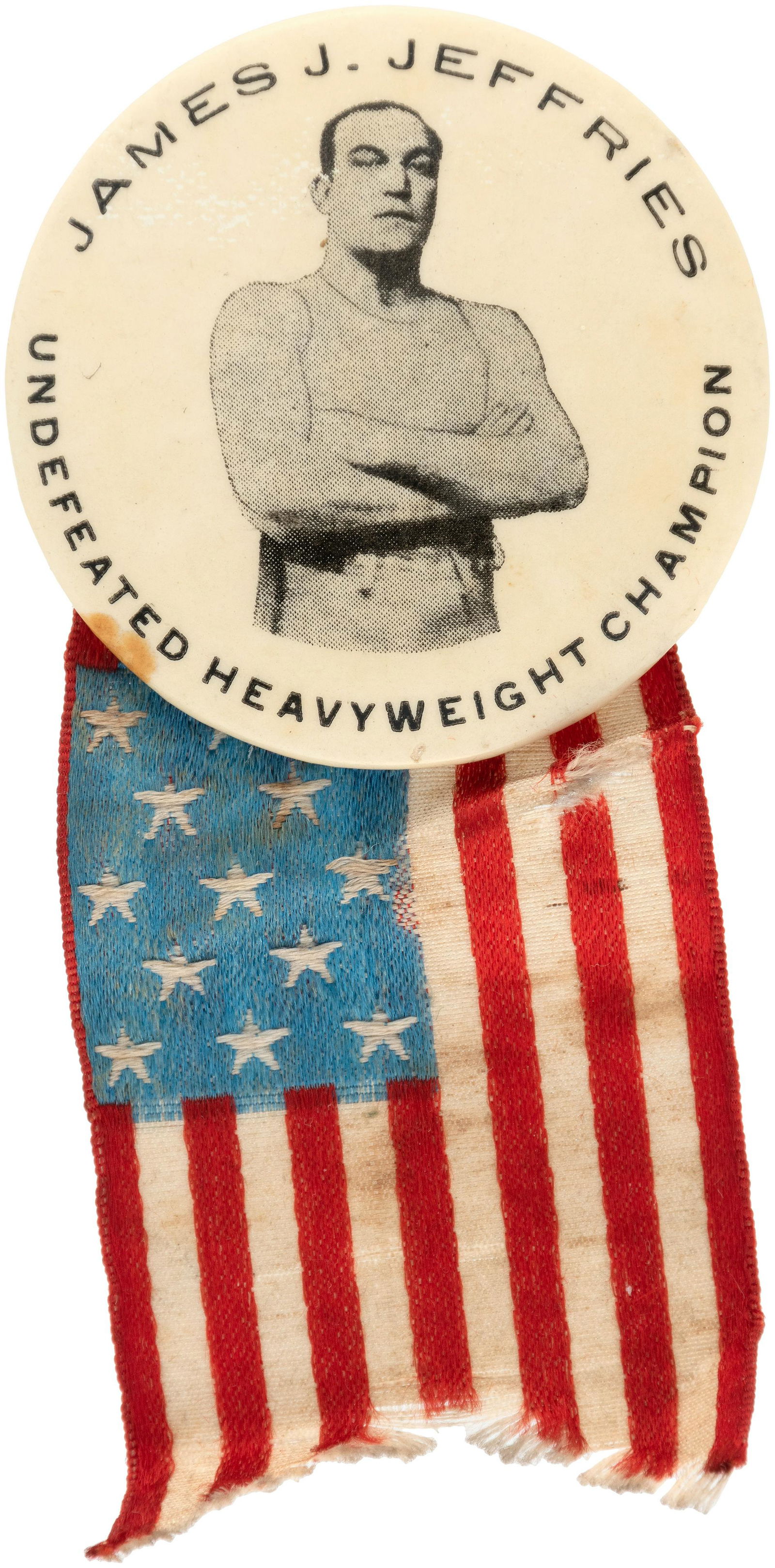 "JAMES J. JEFFRIES UNDEFEATED HEAVYWEIGHT CHAMPION": Similar to the previous item, produced for his 1910 Reno bout with Jack Johnson but this is 1.75" with back paper of M.E. Cunningham, Pittsburg which has .25" tan dot and a ripple crease in the paper