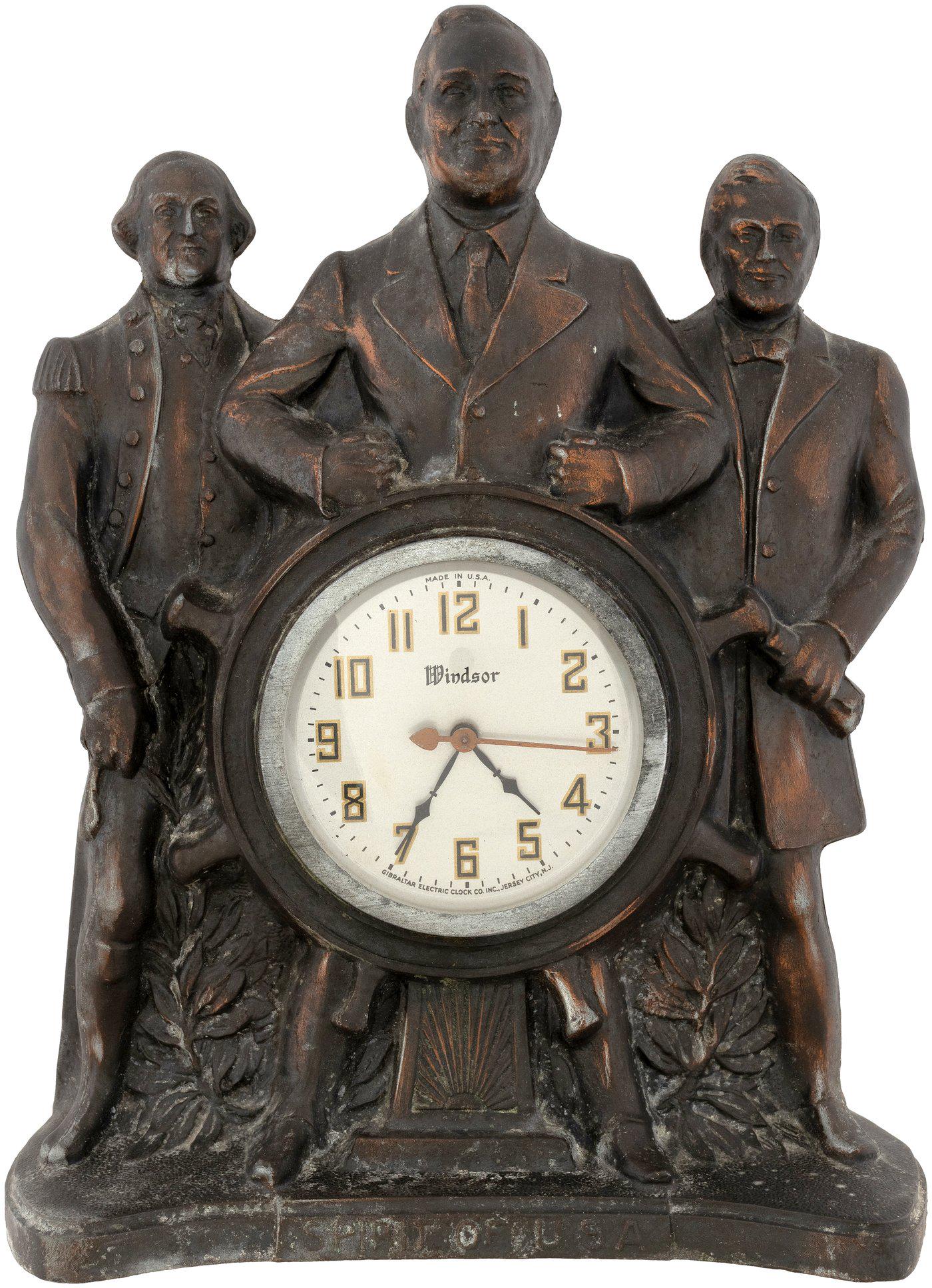 ROOSEVELT, WASHINGTON AND LINCOLN "SPIRIT OF USA" MANTLE CLOCK.: 11x5.5x15". Metal figural clock featuring FDR w/Washington and Lincoln at his side. Text at base reading " Spirit of U.S.A.". Roosevelt is righting the ship, symbolic of him leading America through th