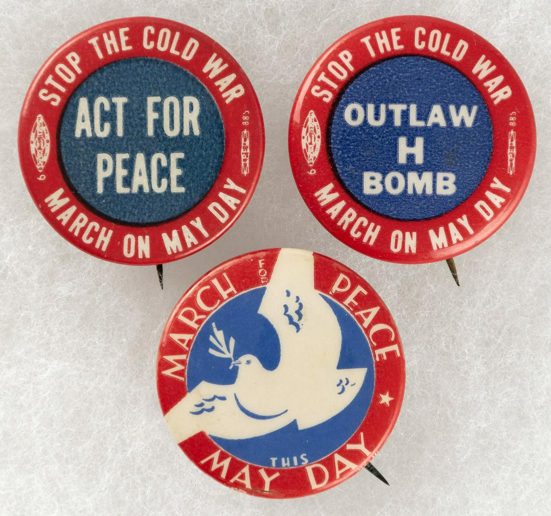 STOP THE COLD WAR MARCH ON MAY DAY COMMUNIST BUTTON TRIO.: Each is 1.25". Left reads "Stop The Cold War-Act For Peace-March On May Day". The center has a dove w/"March For Peace May Day", and the right has text reading "Stop The Cold War-Outlaw H Bomb-March O
