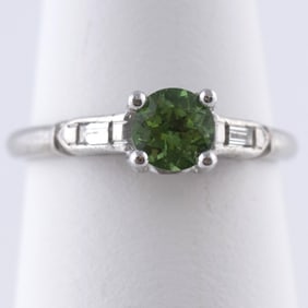 PLATINUM GREEN TSAVORITE GARNET AND DIAMOND RING.