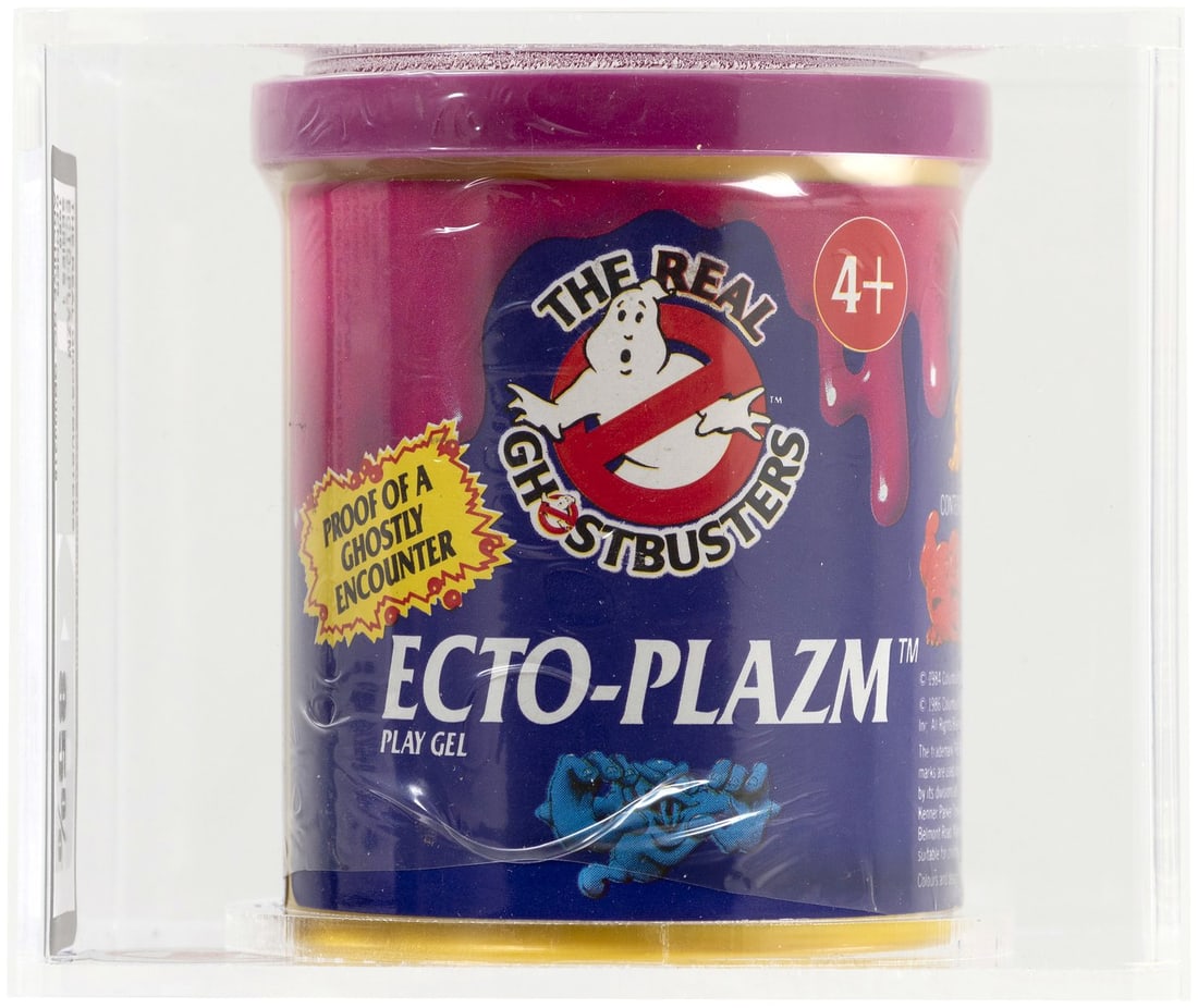 THE REAL GHOSTBUSTERS (1986) - ECTO-PLAZM SERIES 1 (PURPLE) UKG 85%.: UKG graded and encapsulated container of Kenner Ecto-Plazm play gel w/one of three different Ecto-Ghost figurines. Purple Ecto-Plazm color. Mark Warner (UK) Collection.