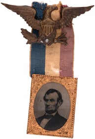 LINCOLN 1864 GEM FERROTYPE PORTRAIT IN BRASS FRAME ON RIBBON.
