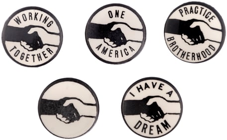 CIVIL RIGHTS COLLECTION OF FIVE BLACK & WHITE HANDSHAKE MOTIF BUTTONS.
