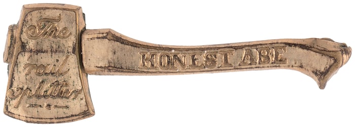 LINCOLN "HONEST ABE THE RAIL SPLITTER" 1860 FIGURAL AXE BRASS SHELL BADGE.