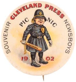 NEWSBOYS PICNIC CARTOON BUTTON W/THE “PRESS” AS A COP AND BILLY CLUB TITLED “THE
