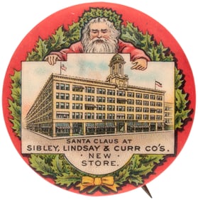 SANTA CLAUS BUTTON C. 1905 W/SANTA PRESENTING A SIGN BOARD SHOWING THE STORE.