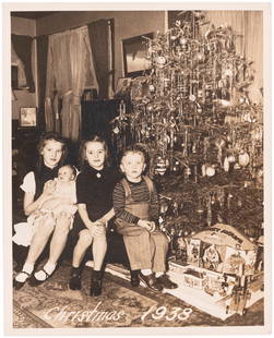 LIONEL MICKEY MOUSE CIRCUS TRAIN "CHRISTMAS 1938" ORIGINAL HIGH QUALITY PHOTO.: 8x9-7/8" silver gelatin photo on heavy stock w/matte finish shows four children sitting next to Christmas tree w/their opened presents on display. Printed text at bottom of photo reads "Christmas 1938