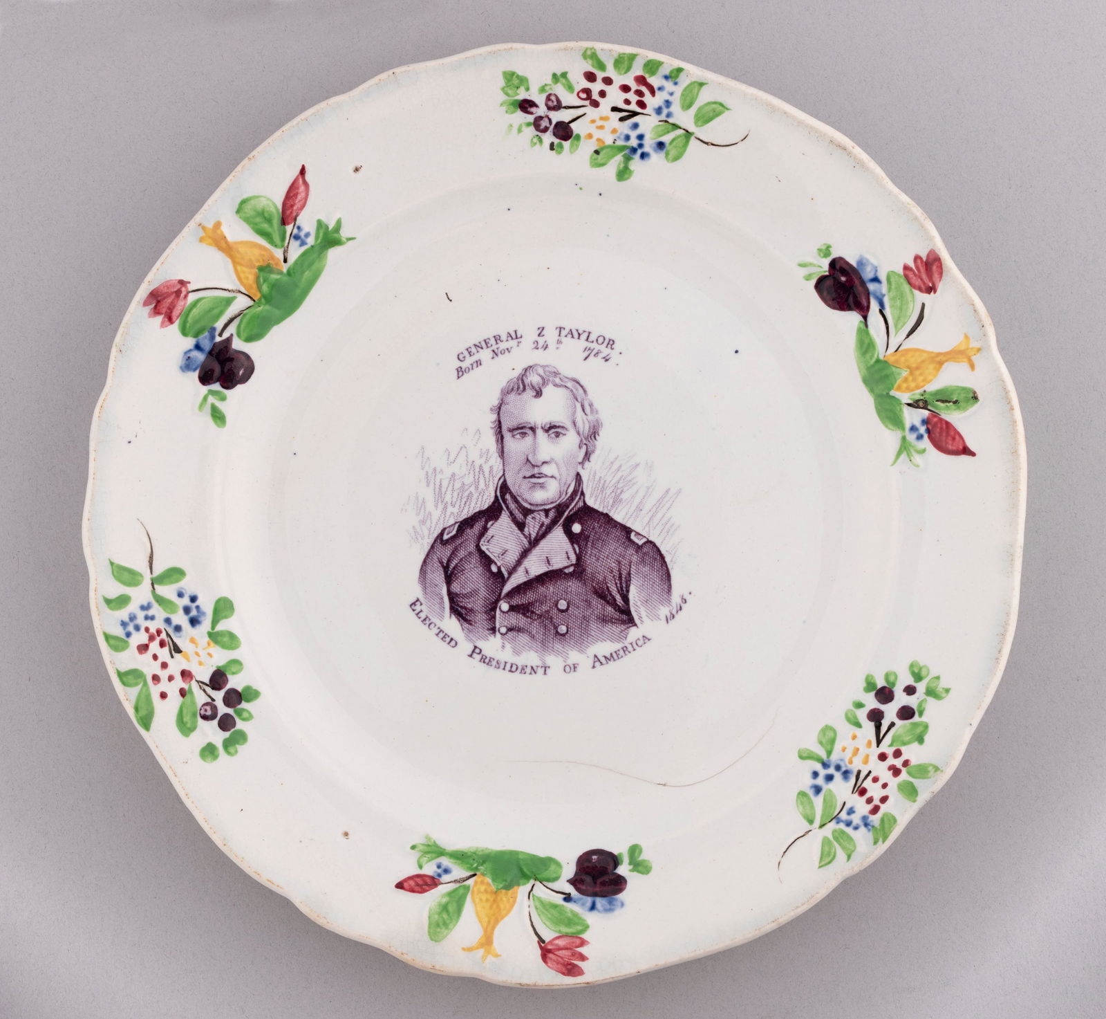 "GENERAL TAYLOR ELECTED PRESIDENT OF AMERICA 1848" PORTRAIT PLATE.: 9.25" dia. "General Z. Taylor Born Nov. 24, 1784. Elected President of America, 1848" text surrounds attractive portrait transfer in mulberry. Stunning polychrome flower bunches at rim, a much bolder