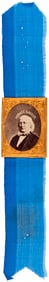"HORACE GREELEY" 1872 BRASS FRAMED GEM ALBUMEN PORTRAIT BADGE ON BLUE SILK RIBBON.