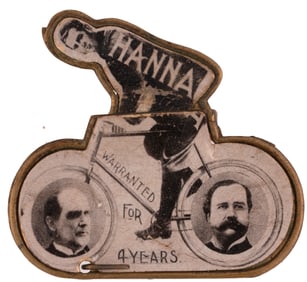 MARK HANNA PEDALS McKINLEY & HOBART TO THE WHITE HOUSE 1896 MECHANICAL BADGE.