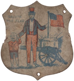 SALUTE THE FLAG TIN LITHO SHIELD W/UNCLE SAM HOLDING MEXICO'S PRESIDENT'S EAR.