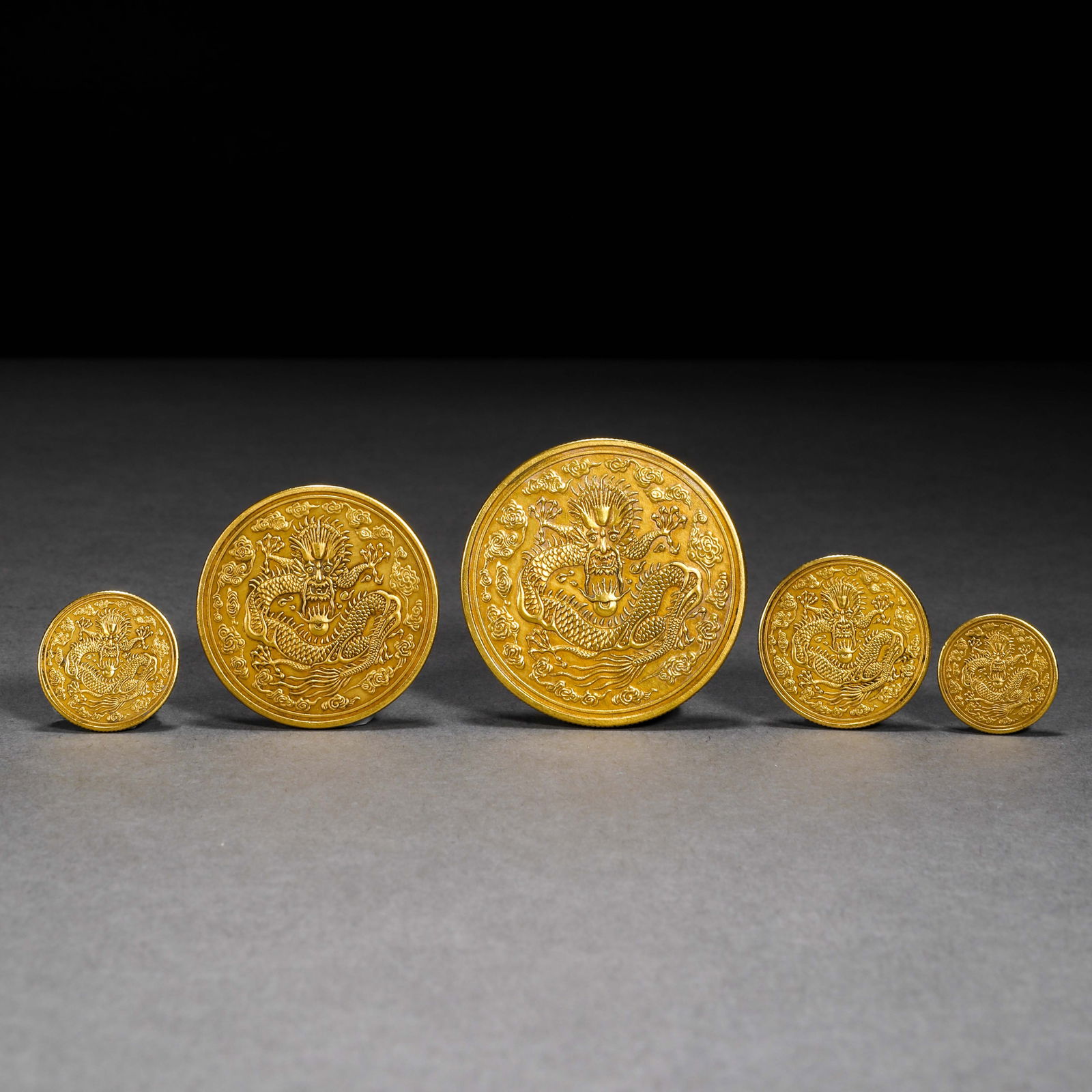 A set of gold dragon-patterned coins from the Dingwei year of the Guangxu reign of the Qing Dynasty (1 of 7)