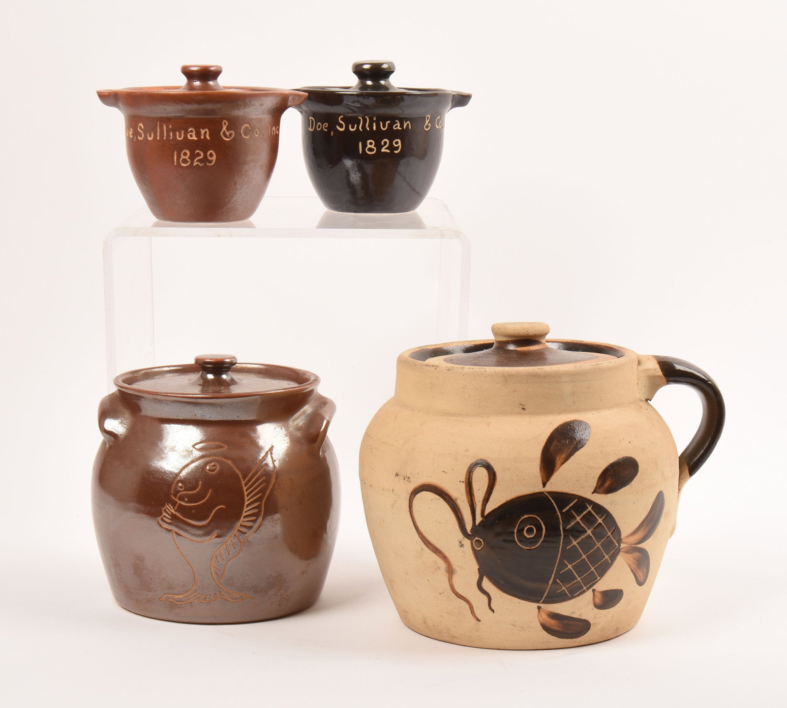Dorchester Pottery Lot: four covered jars in various size covered in brown glazes. 6 1/4 inches high, 7 3/4 inches wide, 6 3/4 inches deep (largest). Two marked Dorchester Pottery, one marked Knesseth Denisons. one marked C.