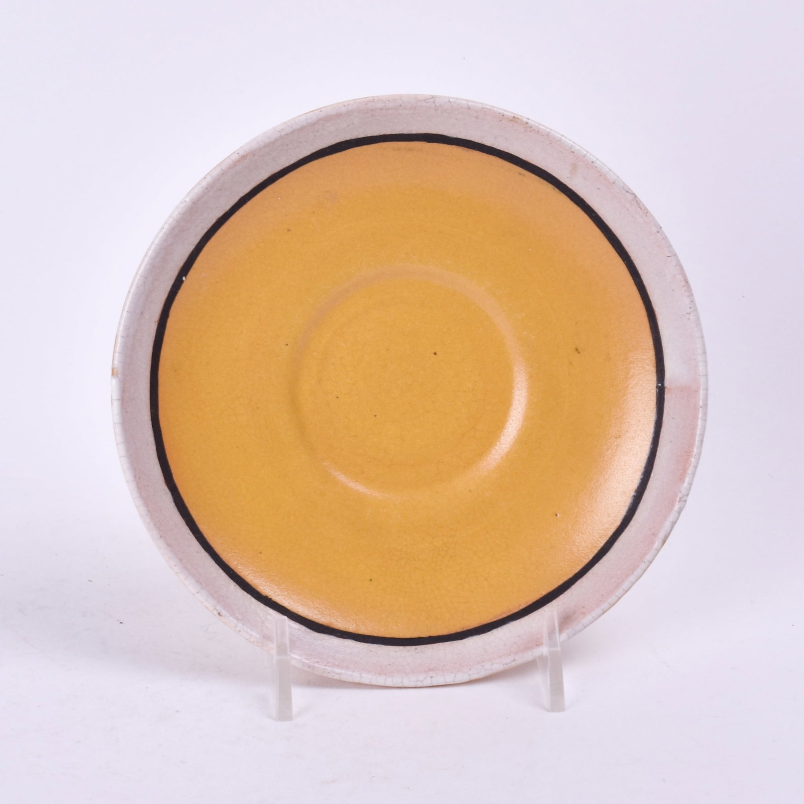 Saturday Evening Girls Saucer: with a yellow glaze and cream band. 3/4 inch high, 5 3/4 inches diameter, marked SEG/3-20/EW.