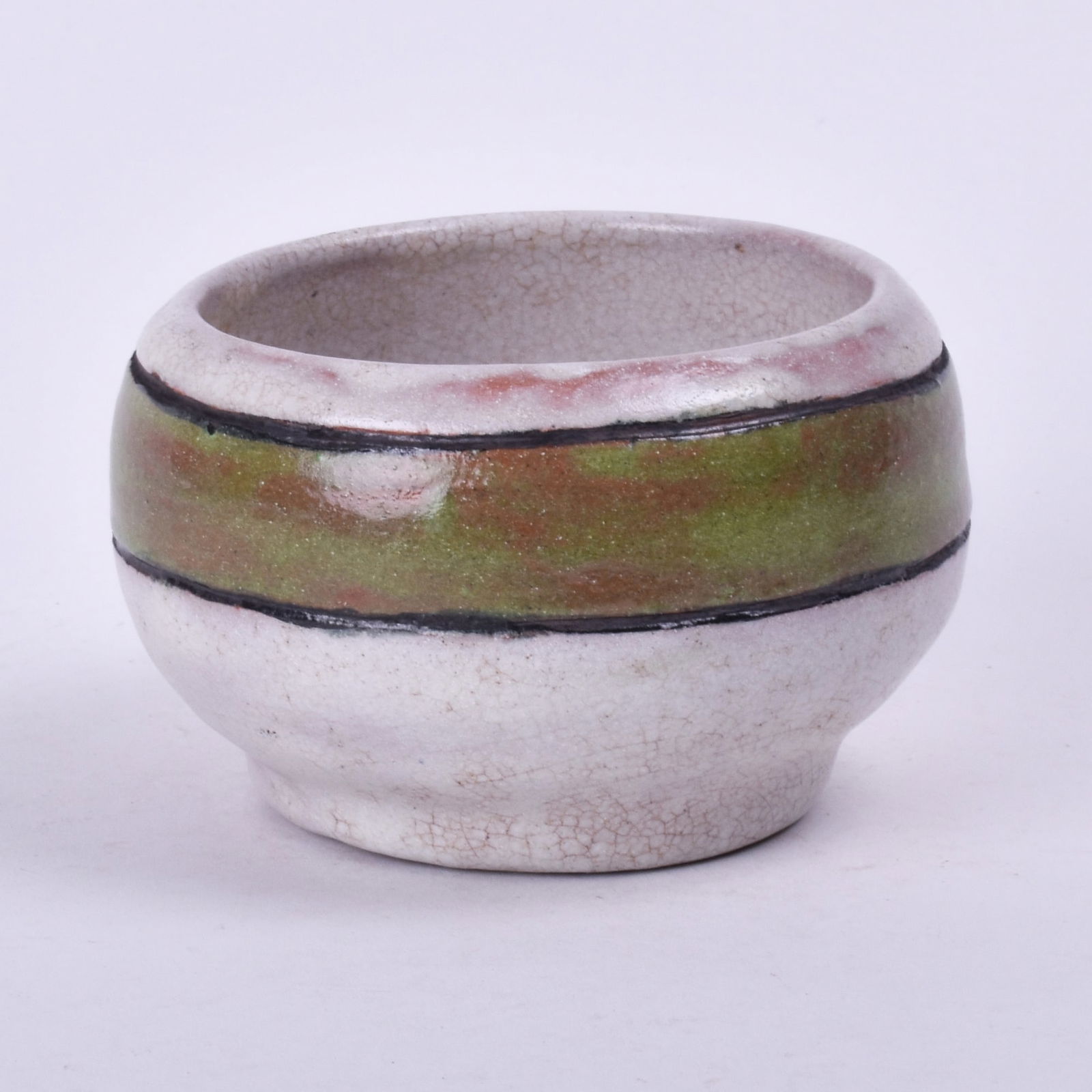 In the style of Saturday Evening Girls (Paul Revere Pottery) Bowl: with a green band on a white background. 2 1/2 inches high, 4 inches diameter, painted M.M. J. Lots 45, 46, and 47 came together from a New England estate.