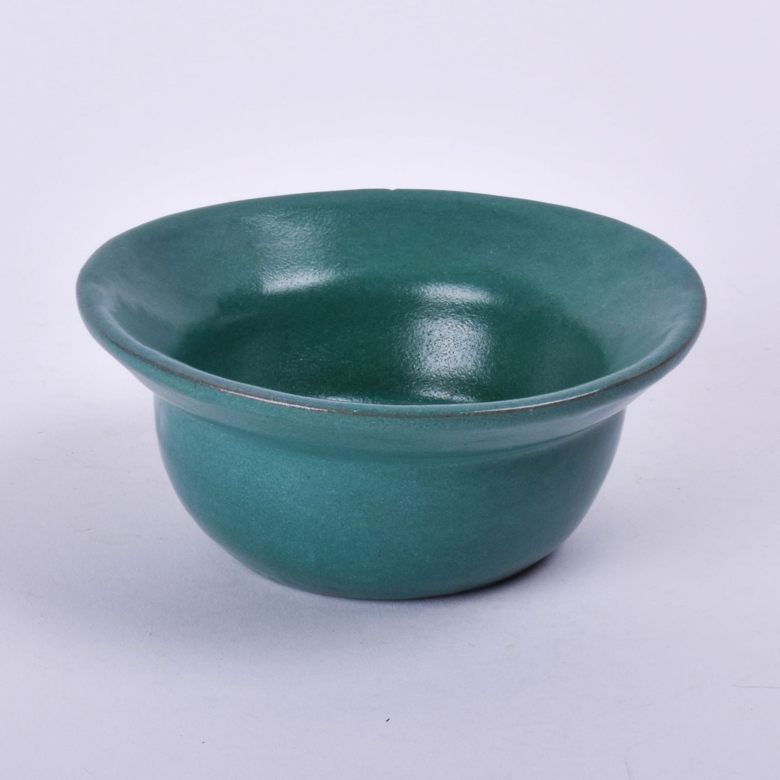 In the style of Saturday Evening Girls (Paul Revere Pottery) Bowl: with a blue-green glaze. 2 1/8 inch high, 5 inches diameter, incised M.M. J. Lots 45, 46, and 47 came together from a New England estate.