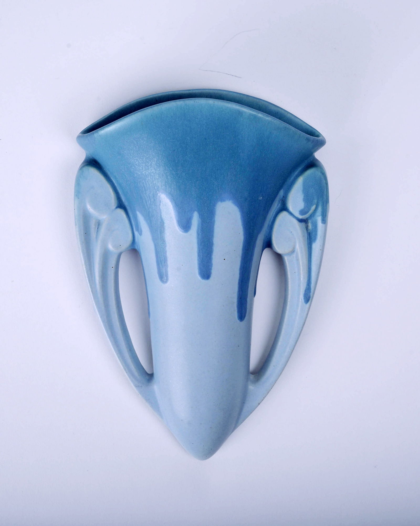 Roseville Pottery Blue Carnelian I Wallpocket: 8 1/2 inches high , 5 1/2 inches wide, 2 1/4" deep, marked with blue Rv inkstamp nad black paper label, 125/8.