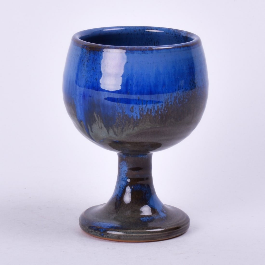 Shearwater Pottery Goblet: covered in a flowing blue over green-brown glaze. 4 inches high, 3 inches diameter, marked impressed Shearwater, JA, 00.