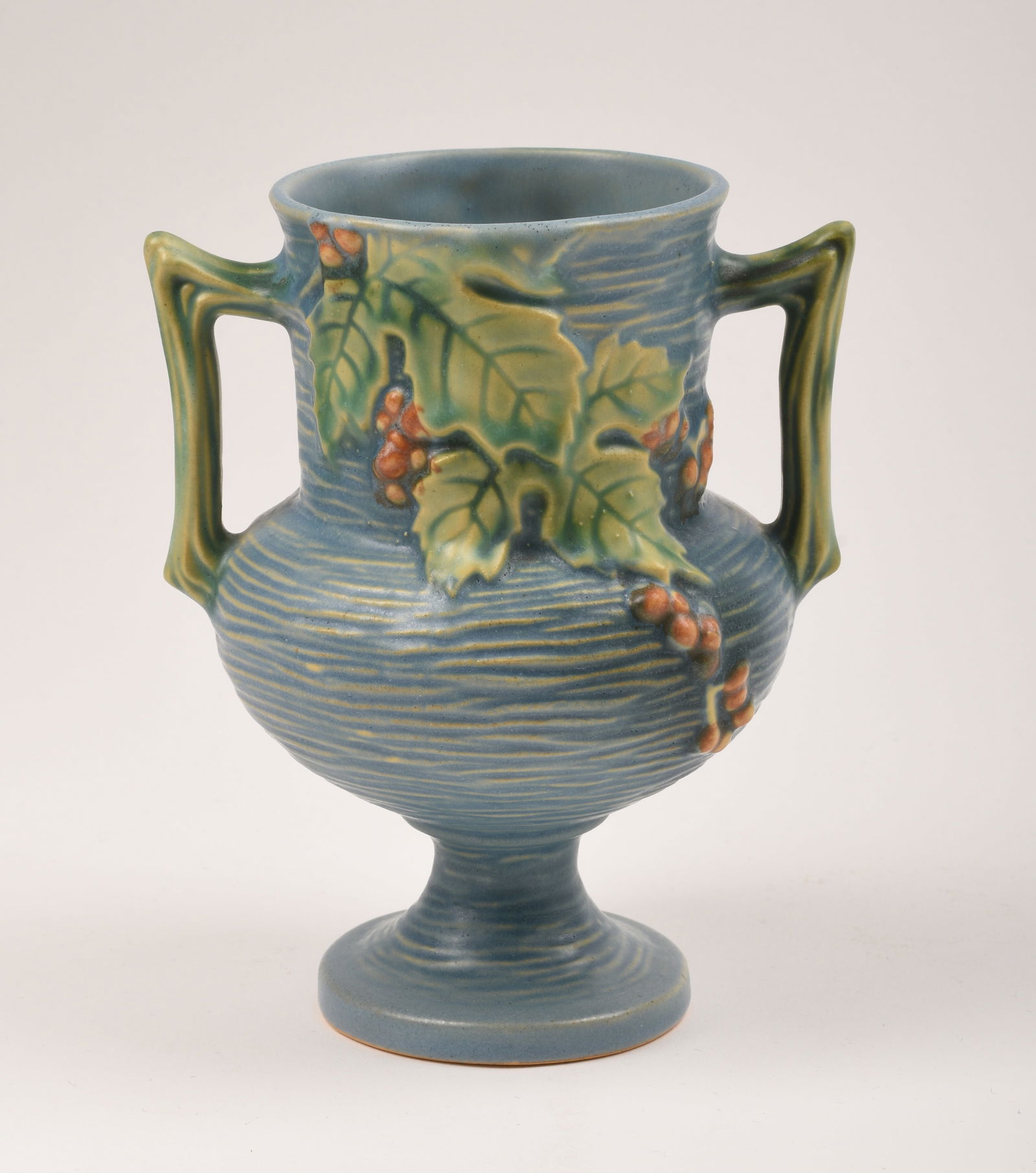Roseville Pottery Blue Bushberry Vase: 6 1/4 inches high, 5 inches wide, 4 inches deep, marked Roseville U.S.A. 156-6