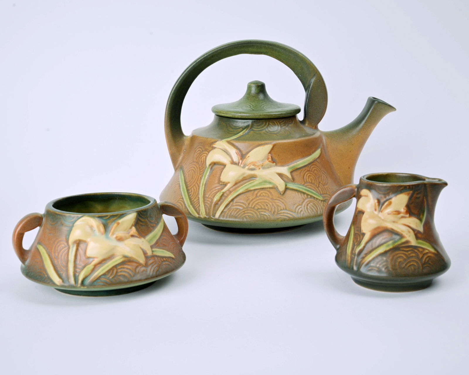 Roseville Pottery Brown Zephyr Lily Tea Set: 7 1/8 inches high, 9 inches wide, 7 5/8 inches deep (teapot), marked Roseville U.S.A 7-T.