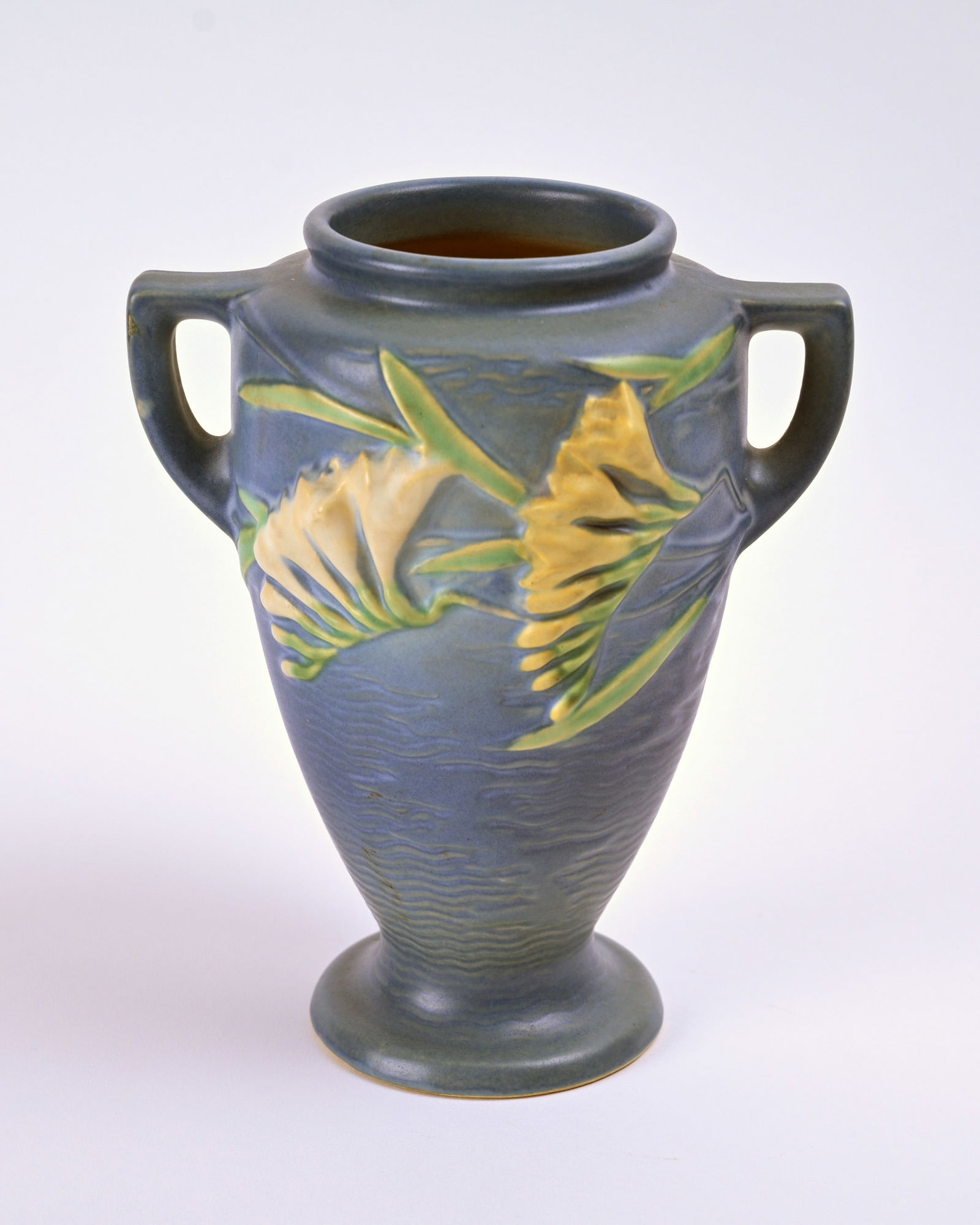 Roseville Pottery Blue Freesia Vase: 8 1/4 inches high, 6 7/8 inches wide, 5 1/4 inches deep, marked Roseville U.S.A 121-8.