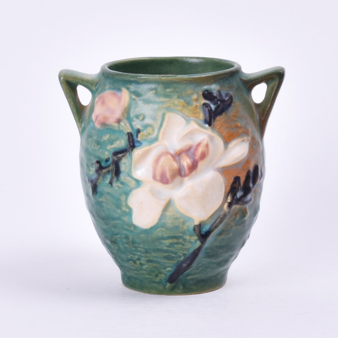 Roseville Pottery Green Magnolia Vase: 4 1/8 inches high, 4 1/4 inches wide, 4 inches deep, marked Roseville U.S.A 86-4.
