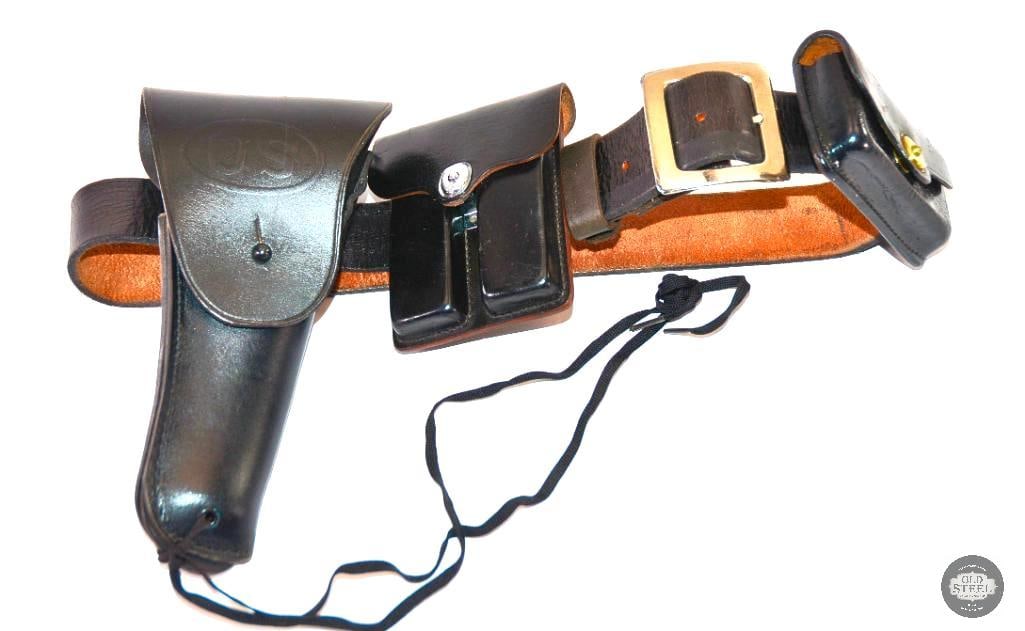 1960's Leather Pistol Belt System for 1911 Pistol: This lot contains a black leather pistol belt system for the 1911 pistol. On the belt is a garrision style dual mag pouch, topflap holster with US embossed on the front and an addition short pouch. Th