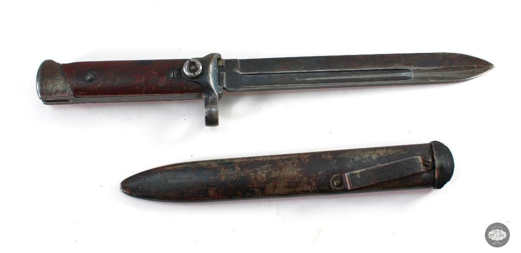 Italian M1938 Carcano Folding Bayonet - 2nd Variant: Here we have a great example of the M1938 Carcano folding bayonet. This is the 2nd variant, evidenced by the blade notch and knurled end on the back of the blade (visible when folded. This bayonet com