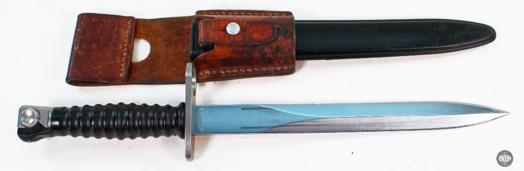 Swiss M1957 Bayonet and Belt Frog: This lot has a Swiss M1957 Bayonet with scabbard and frog. Some surface wear in places. The blade has a shallow nic about a quarter inch wide on the blade edge toward the ricasso. The reverse of the f