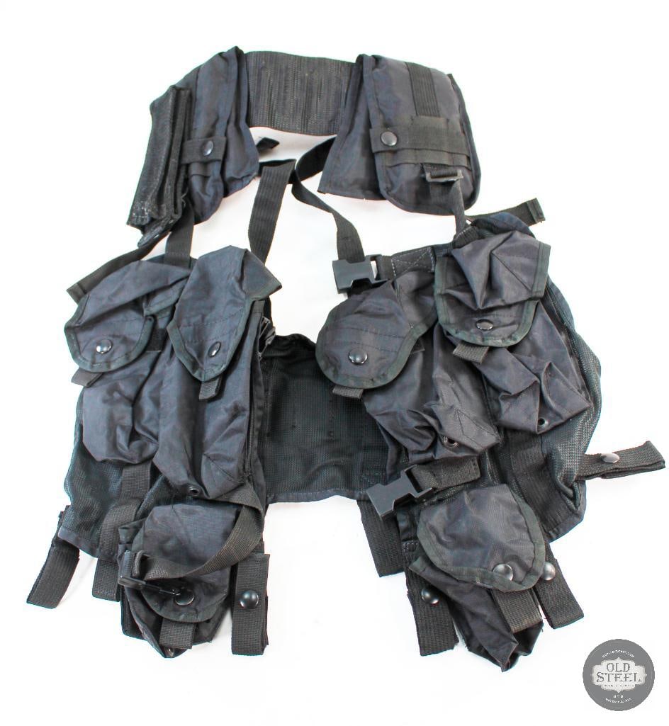 Black Nylon Chest Rig: Black nylon chest rig. 4 mag pouches and 2 grenade pouches. The rig has padded shoulders. THIS ITEM IS AS PICTURED WITH NO FURTHER ATTACHMENTS. ALL SA