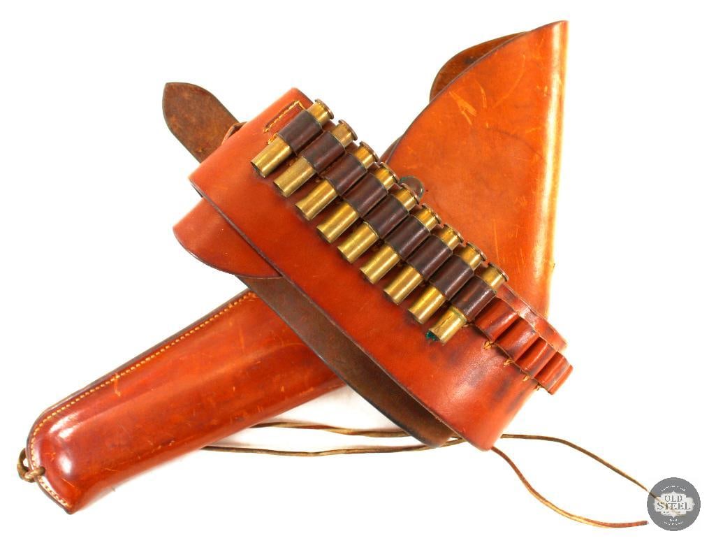Fred Mueller Custom Leather Holster and Bandoleer: A Fred Mueller make custom leather holster for a VERY large (14in) revolver and matching belt bandoleer with 9 spent 45-70govt brass casings.The holster features a snap closure and the belt is clasped