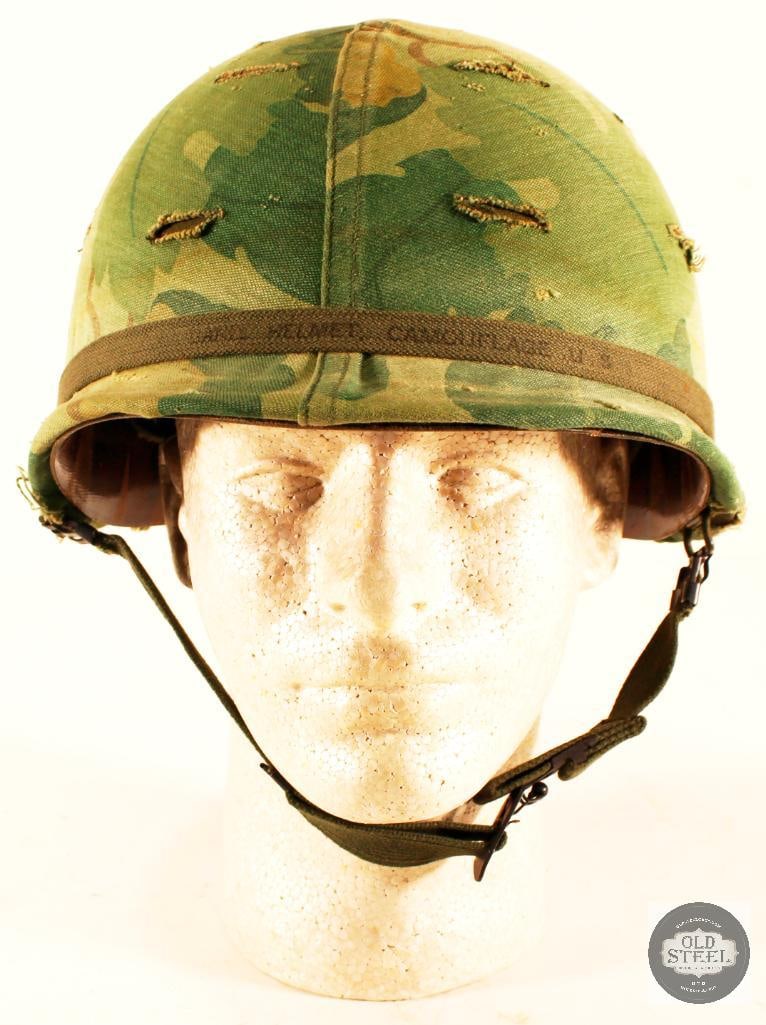 USMC M1 Helmet and Mitchell Cover - Vietnam: This lot contains a Vietnam era USMC M1 helmet, with the recognizable Mitchell camo-pattern cover. The helmet has its liner and chinstrap, and is in good condition overall. 