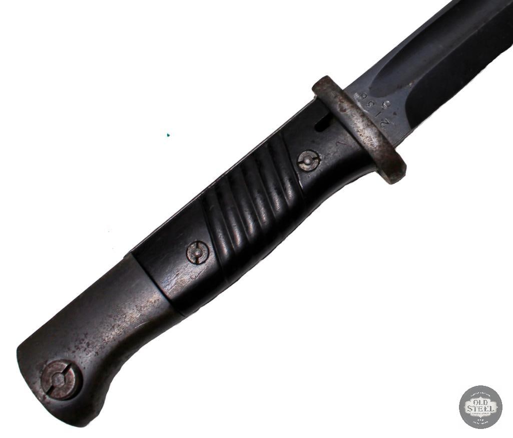 M1884/98 III Bayonet and Scabbard with Frog German WWII: An excellent M1884/98 bayonet with scabbard and frog (not matched) The phenolic resin grips are in good condition. Ricasso is marked 2138 e on one side and E.PACKS&S on the other. 