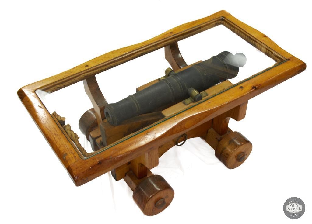 Cannon Coffee Table: Decorative cannon coffee table made of wood. 42Lx22Wx17H. Glass pane top. Wheels are fixed in place. Local pickup only. Very cool! THIS ITEM IS AS PIC