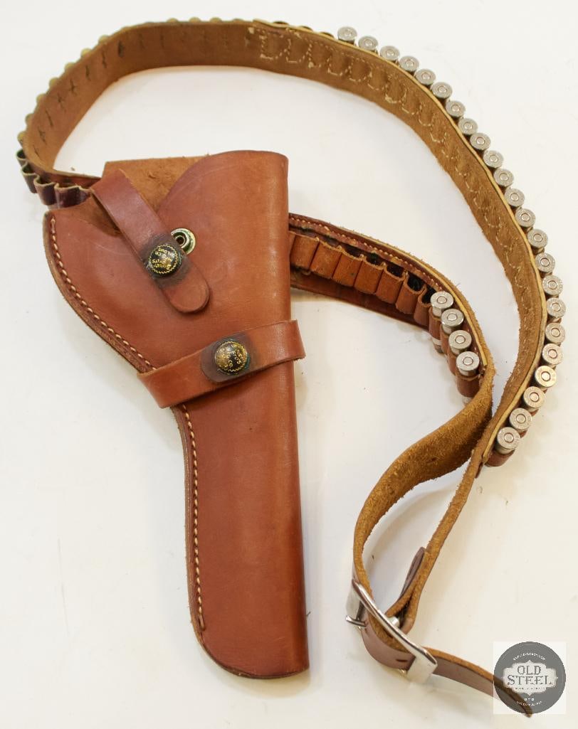 Cartridge Gun Belt and Holster: Brown leather cartridge gun belt and holster with loops for 38SPL and 22LR. Open muzzle 6.5 inch holster by Brauer Bros Mfg Co. Comes with some ammo of each cartridge mentioned. 