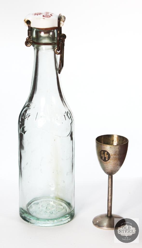 Original Carlsberg Beer Bottle 1935 and SS Sterling Silver Cup: A Carlsberg beer bottle from 1935, Great condition and measuring about 9 inches tall. Next to it is a 4 inch SS marked cup that appears silver or silver plated. 