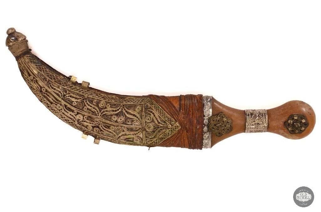 Small Yemenite Jambiya Thouma Dagger: Small Yemenite Jambiya Thouma dagger no belt. Scabbard is leather wrapped wood with brass ornementation. The blade is about 6 inches long. THIS ITEM I