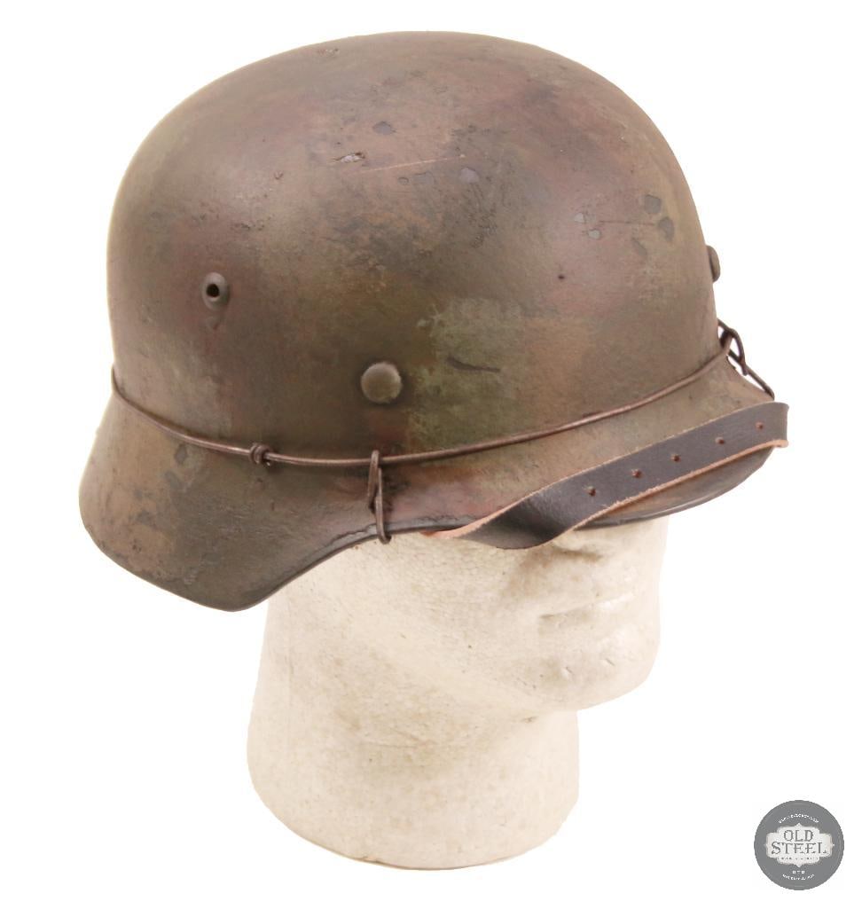 M40 German WWII Stahlhelm With Wire & Camo Paint: Original German M40 steel helmet shell, professionally refurbished with new liner, paint, and applied wire with camouflage finish. Refurbishment presents a WWII-style field appearance while retaining