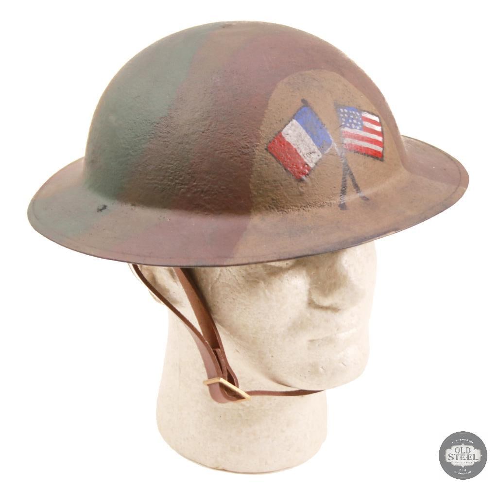 M1917 US WWI Doughboy Helmet with Camouflage and Flag Paint: Original American Brodie steel helmet shell, professionally refurbished with new liner, paint, and applied camouflage finish with flag art. Refurbishment presents a WWII-era field appearance while