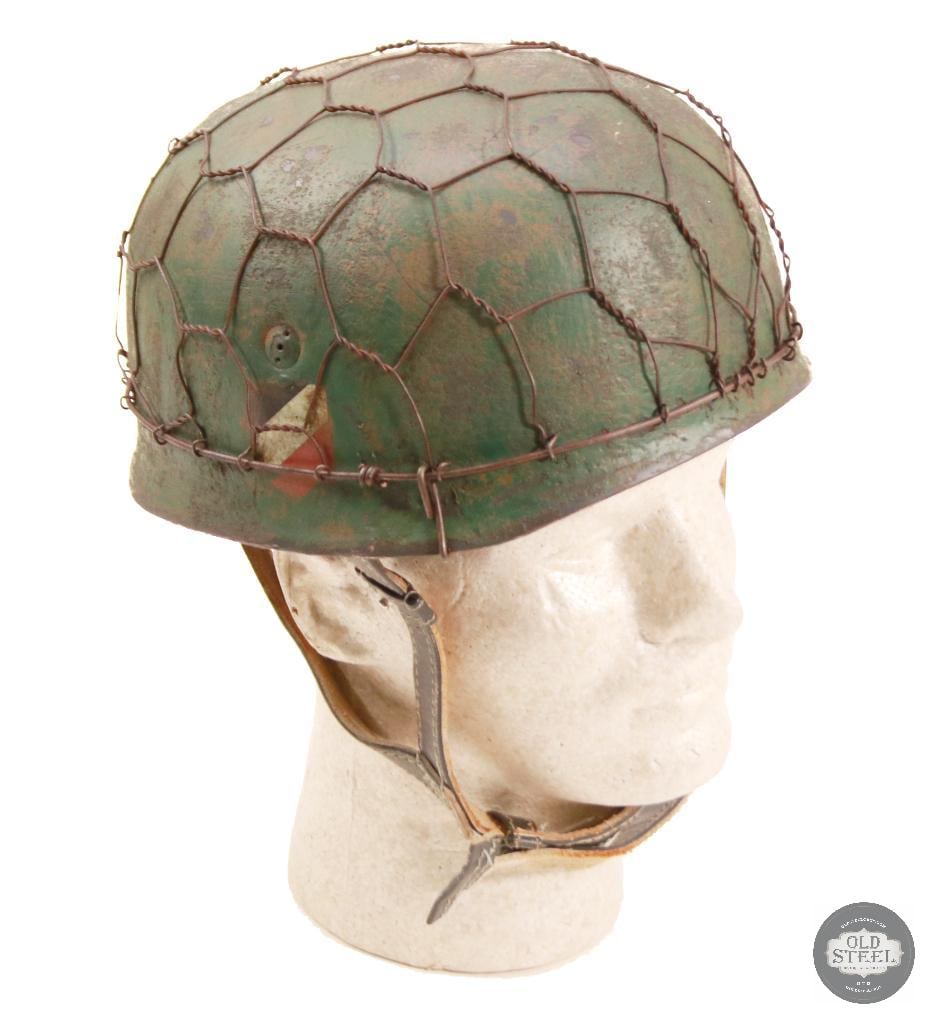 M38 Fallschirmjager German WWII Paratrooper Helmet With Chicken Wire and Camo Paint: Original German M38 paratrooper steel helmet shell, professionally refurbished with new liner, paint, and applied chicken wire with camouflage finish. Refurbishment presents a WWII-style airborne fiel