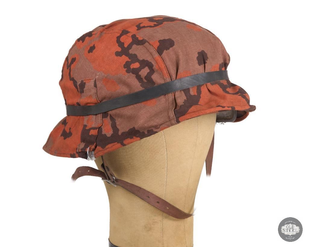 Original German M40 Stahlhelm with Waffen SS Autumn Oak Leaf Camo Cover: Original German M40 Stahlhelm with Waffen SS Autumn Oak Leaf Camo Cover. Helmet shell is original with ET66 factory marking and 4057 Lot number marking with early refurbishing of paint and decals.